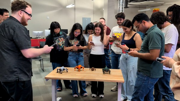 Students photographing the Sesame robots